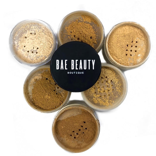 6 containers of setting powder with powder colors showing and no lid. Bae Beauty Boutique logo in the center resting atop the powders.