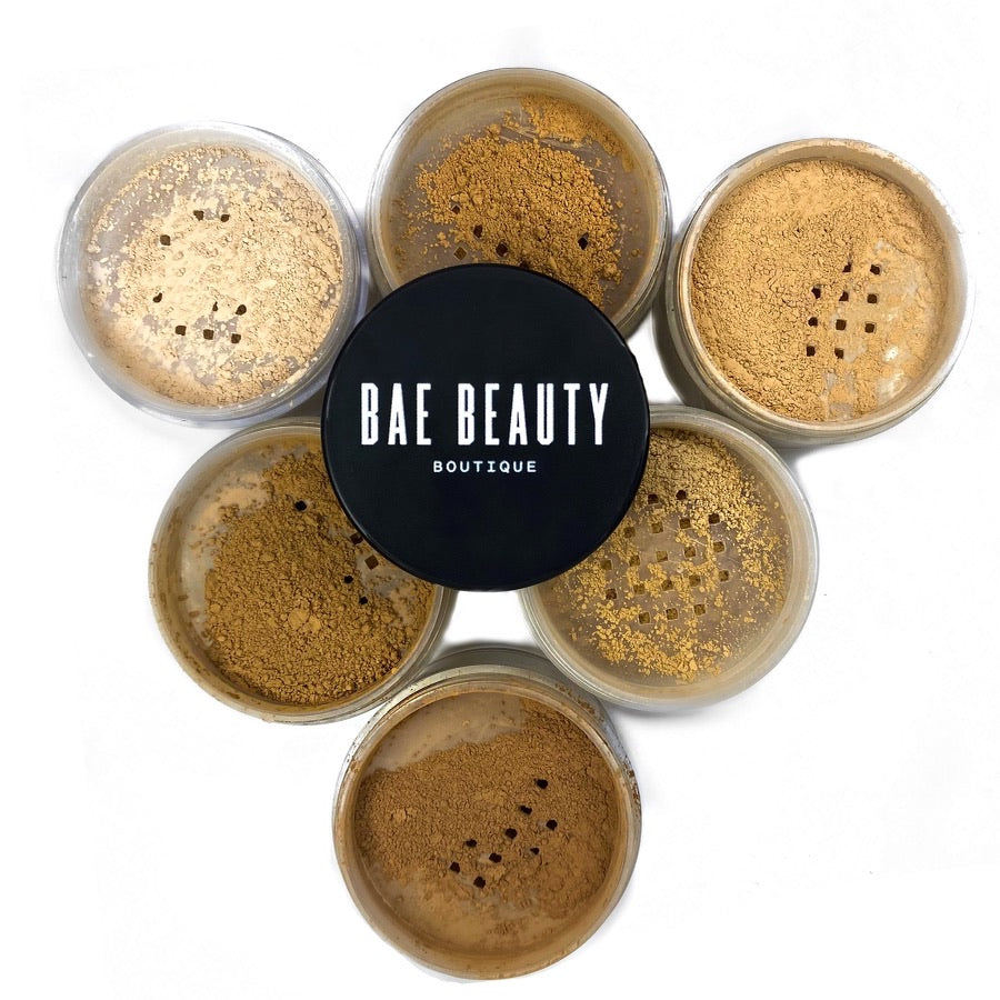 6 containers of setting powder with powder colors showing and no lid. Bae Beauty Boutique logo in the center resting atop the powders.